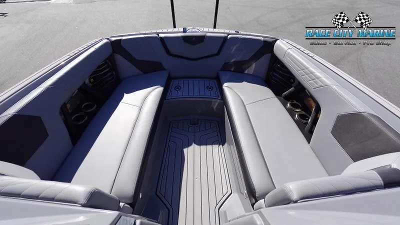 Slide: The Image of 2021 Nautique Super Air Nautique G25 interior with gray seating and cup holders. - 43