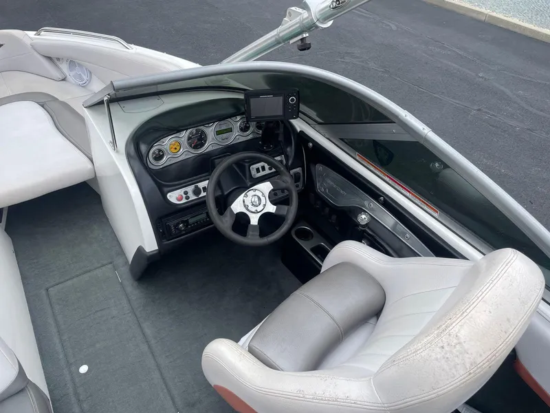 Slide: The Image of 2005 MasterCraft X-10 boat interior, featuring steering wheel and dashboard controls. - 13