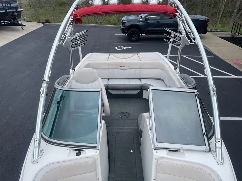 Slide: The Image of 2005 MasterCraft X-10 boat interior with red bimini top and wakeboard racks. - 17