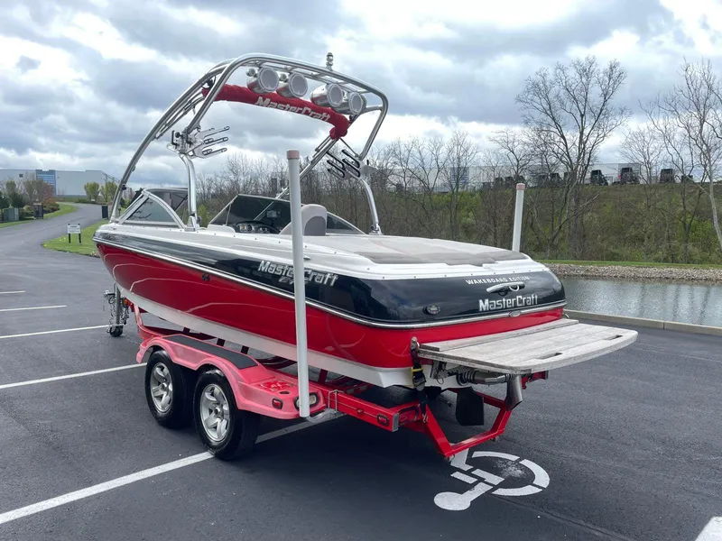 Slide: The Image of 2005 MasterCraft X-10 boat on trailer in parking lot. - 2