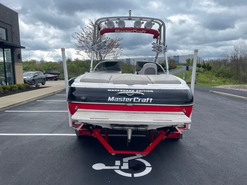Slide: The Image of 2005 MasterCraft X-10 Wakeboard Edition boat parked in a lot. - 4