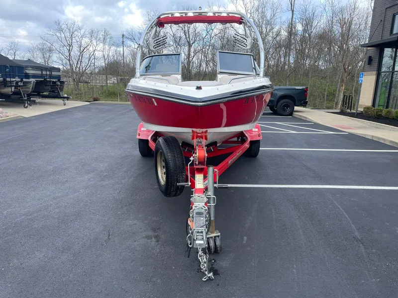 Slide: The Image of 2005 MasterCraft X-10 boat on a red trailer in a parking lot. - 7