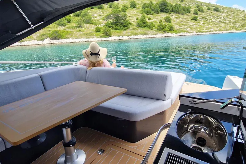 Slide: The Image of Luxury yacht Focus Power 36, 2025 model, with scenic water view and comfortable seating. - 11