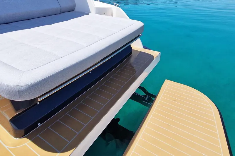 Slide: The Image of Luxury seating on a 2025 Focus Power 36 yacht, overlooking clear blue water. - 13