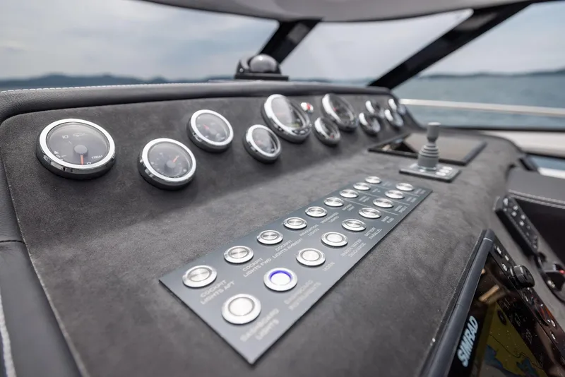 Slide: The Image of Control panel of 2025 Focus Power 36 boat with gauges and buttons, overlooking the sea. - 18