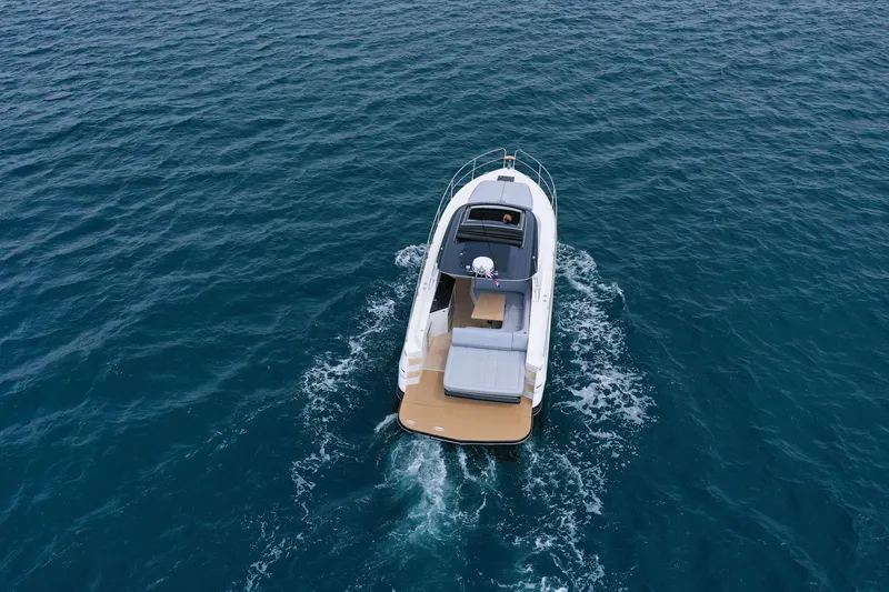 Slide: The Image of 2025 Focus Power 36 boat cruising on open blue water. - 5