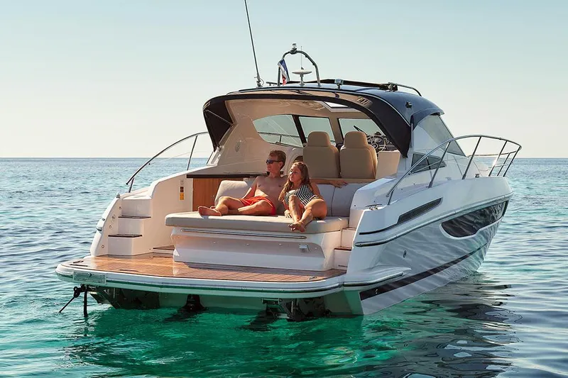 Slide: The Image of 2025 Focus Power 36 yacht on serene water with two people relaxing on deck. - 9