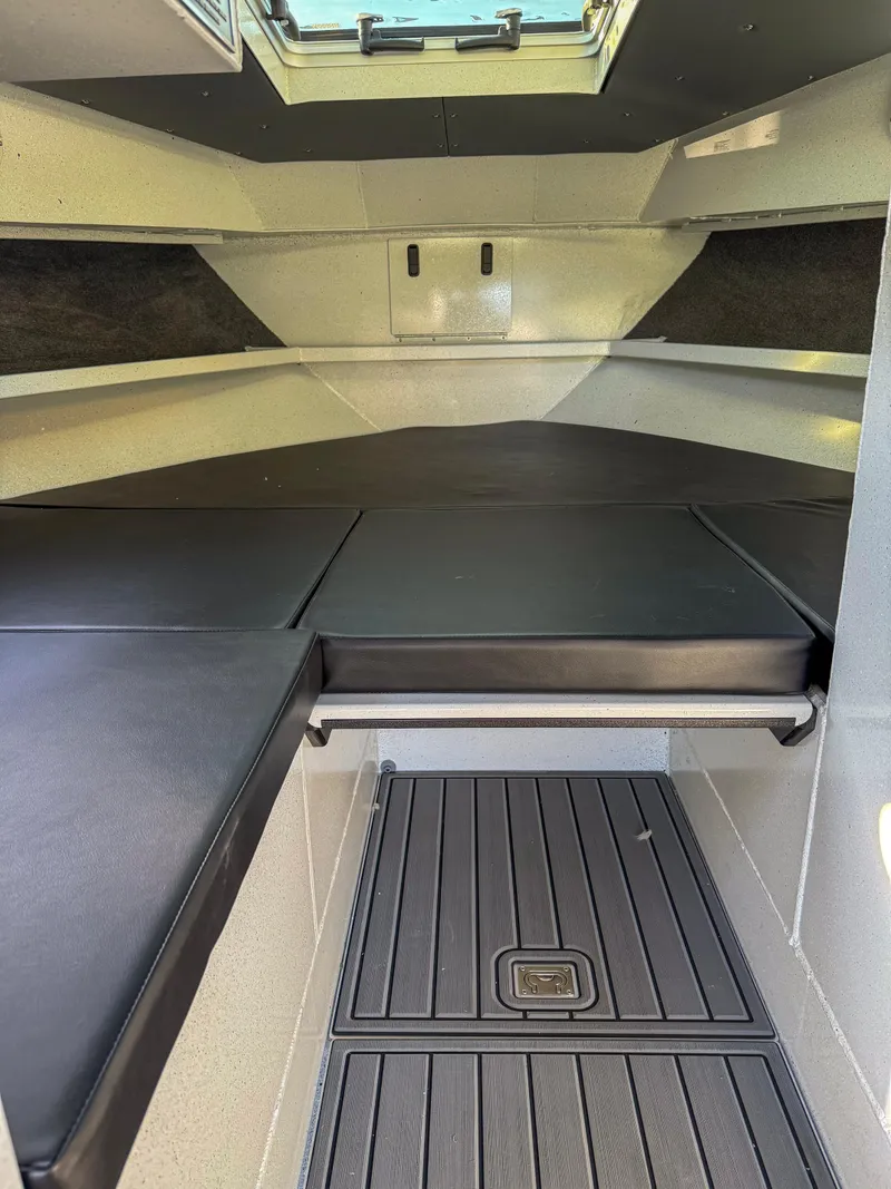 Slide: The Image of 2024 North River Endurance 2800EXL cabin interior with cushioned seating and overhead hatch. - 10