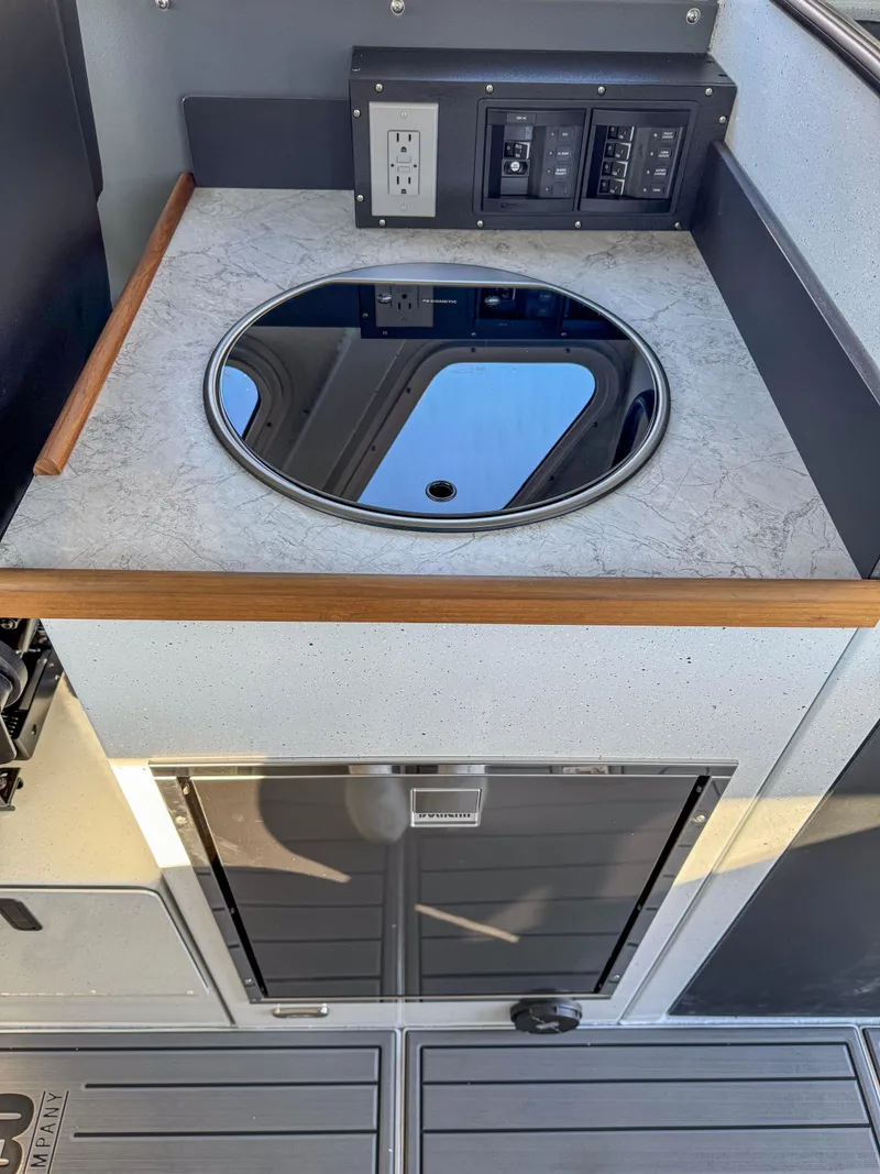 Slide: The Image of 2024 North River Endurance 2800EXL boat interior with sink and control panel. - 11