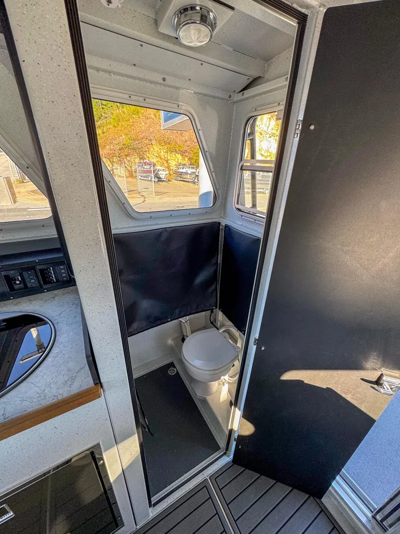 Slide: The Image of 2024 North River Endurance 2800EXL boat interior with compact bathroom. - 12