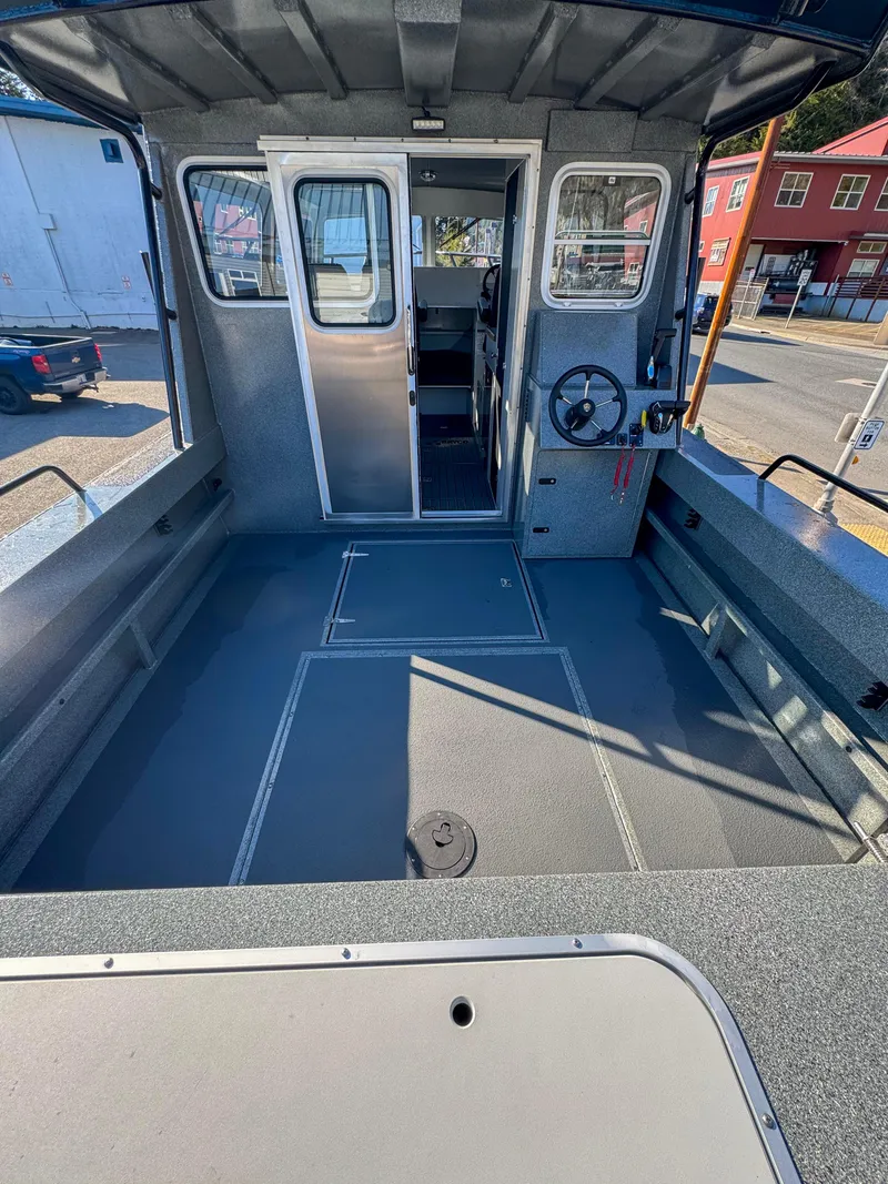 Slide: The Image of 2024 North River Endurance 2800EXL boat interior with spacious deck and modern controls. - 13