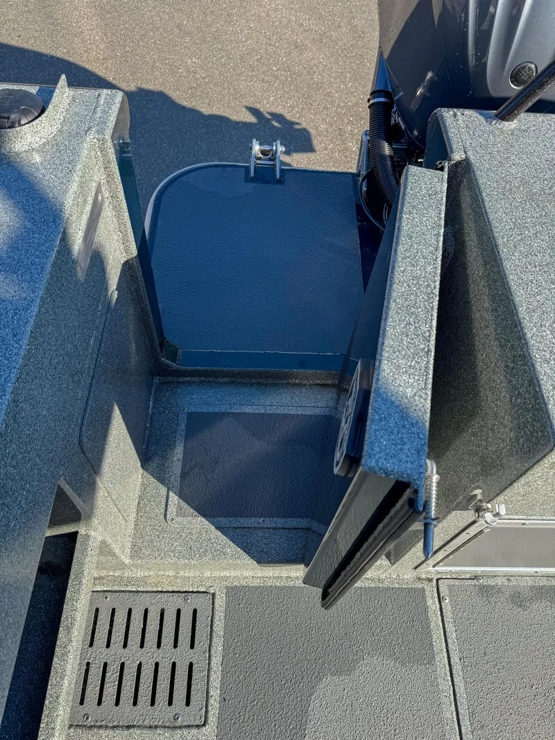Slide: The Image of 2024 North River Endurance 2800EXL boat interior with open storage compartment. - 16