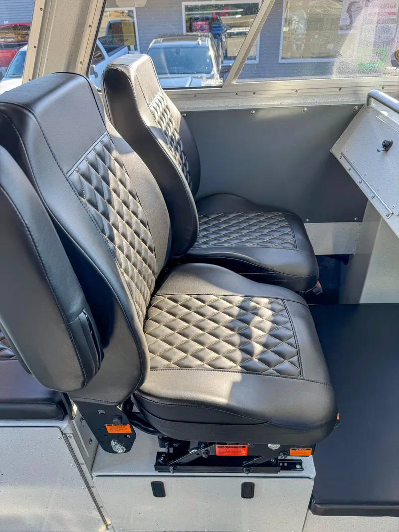 Slide: The Image of 2024 North River Endurance 2800EXL interior with black diamond-stitched seats. - 4