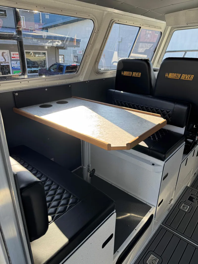 Slide: The Image of Interior of 2024 North River Endurance 2800EXL boat with seating and table. - 5