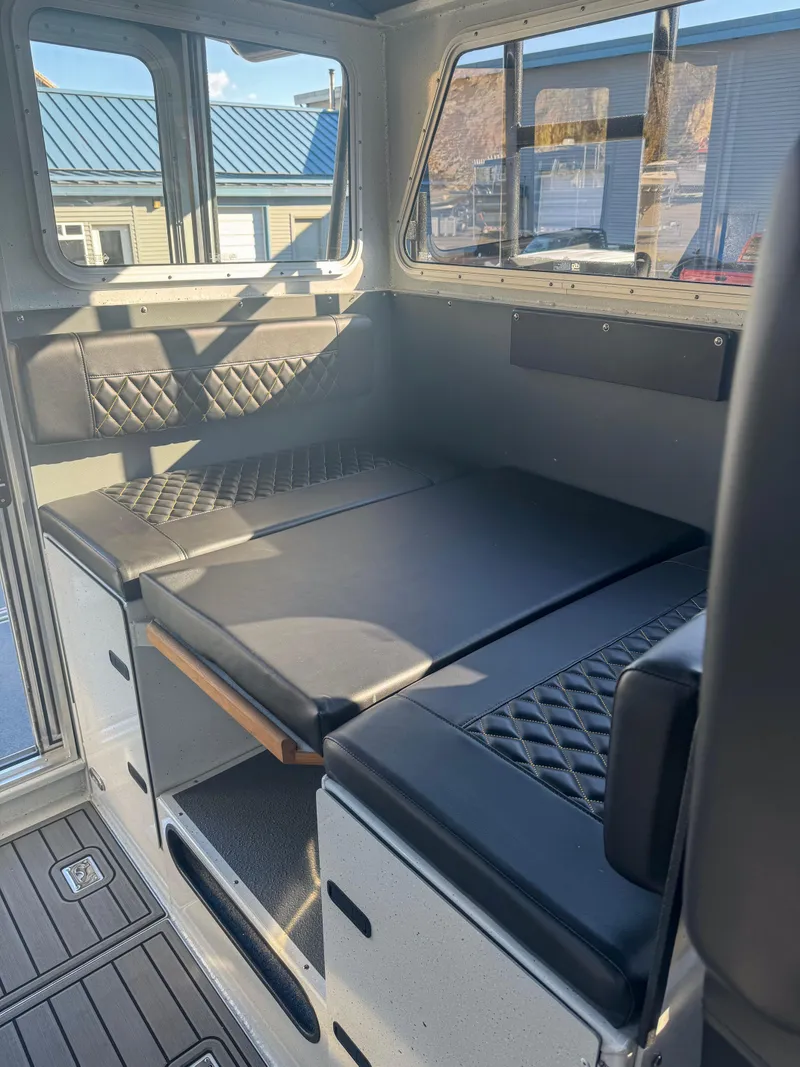 Slide: The Image of 2024 North River Endurance 2800EXL interior seating and storage area. - 8