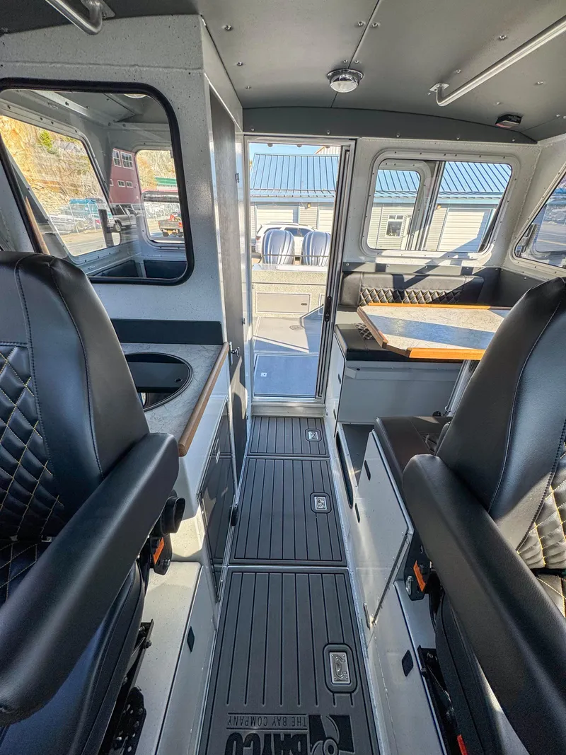 Slide: The Image of 2024 North River Endurance 2800EXL boat interior with seating and dining area. - 9