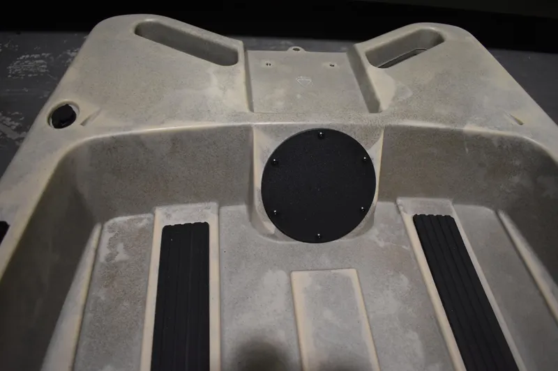 Slide: The Image of 2024 Ascend 128X Yak-Power Sit-On kayak interior with textured footrests and storage compartment. - 15