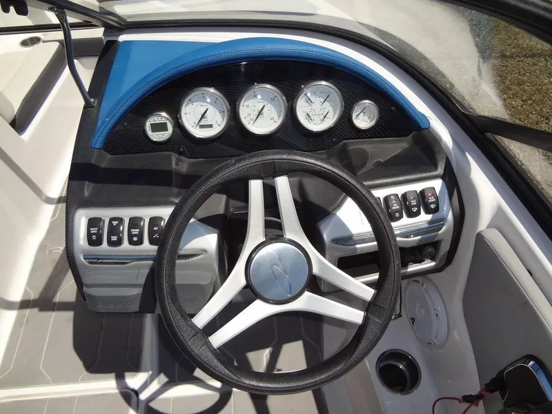 Slide: The Image of 2019 Regal 1900 ESX boat dashboard with steering wheel and gauges. - 17