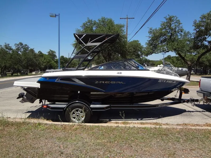 Slide: The Image of 2019 Regal 1900 ESX boat on a trailer in a parking lot. - 6