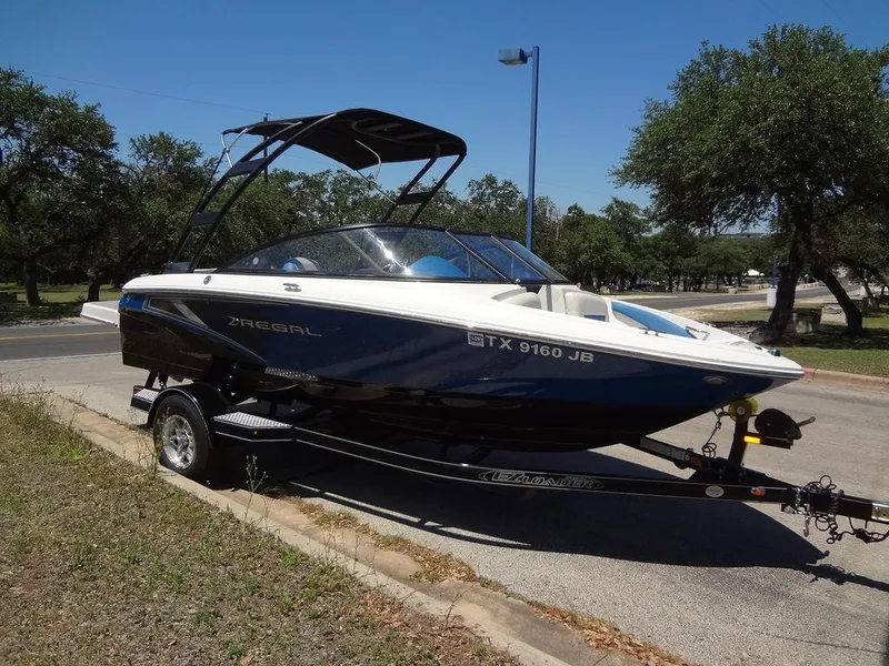 Slide: The Image of 2019 Regal 1900 ESX boat on a trailer in a parking lot. - 7
