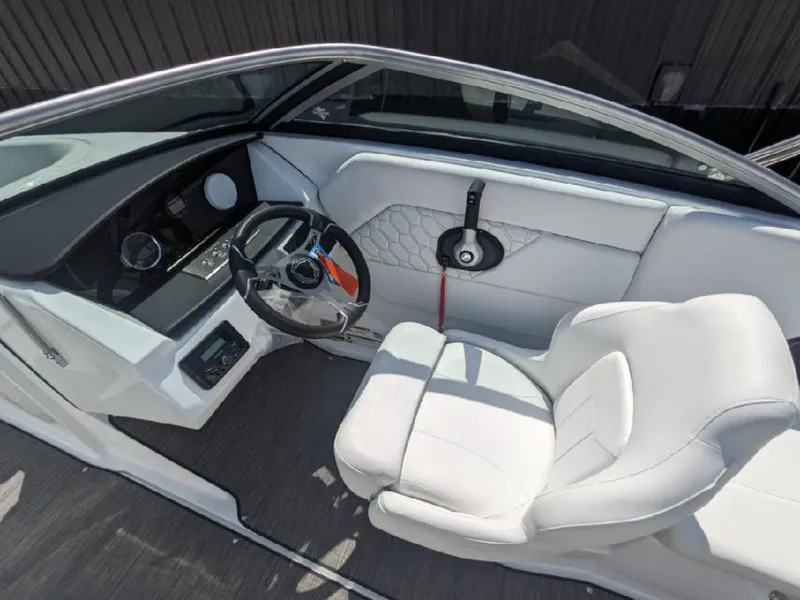 Slide: The Image of 2023 Four Winns H1 OB boat interior with white seating and modern dashboard. - 10