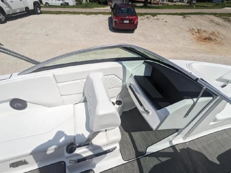 Slide: The Image of 2023 Four Winns H1 OB boat interior with white seating and modern design. - 11