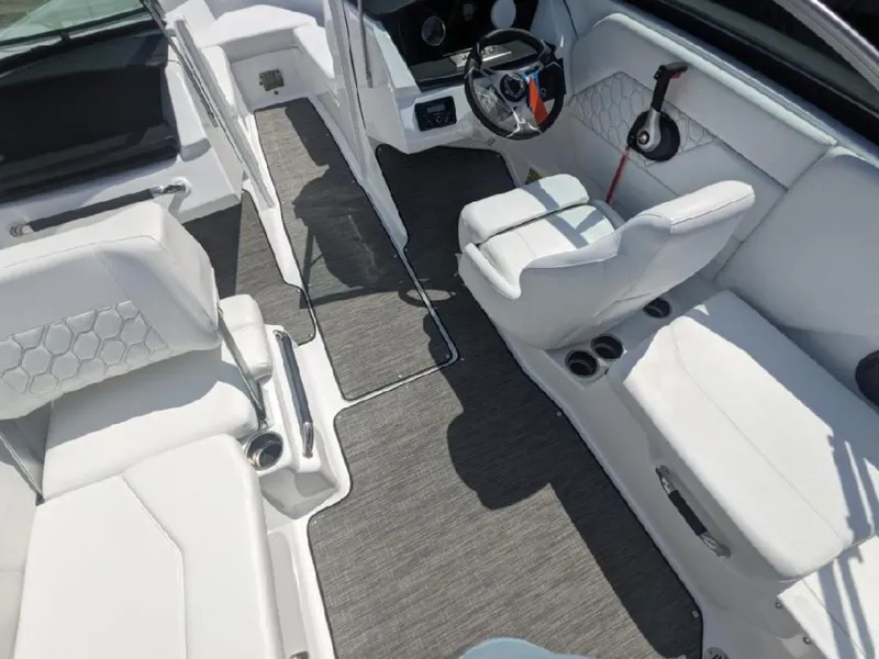 Slide: The Image of 2023 Four Winns H1 OB boat interior with white seating and modern dashboard. - 16