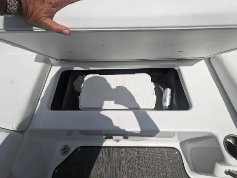 Slide: The Image of 2023 Four Winns H1 OB boat storage compartment with cooler and accessories. - 19