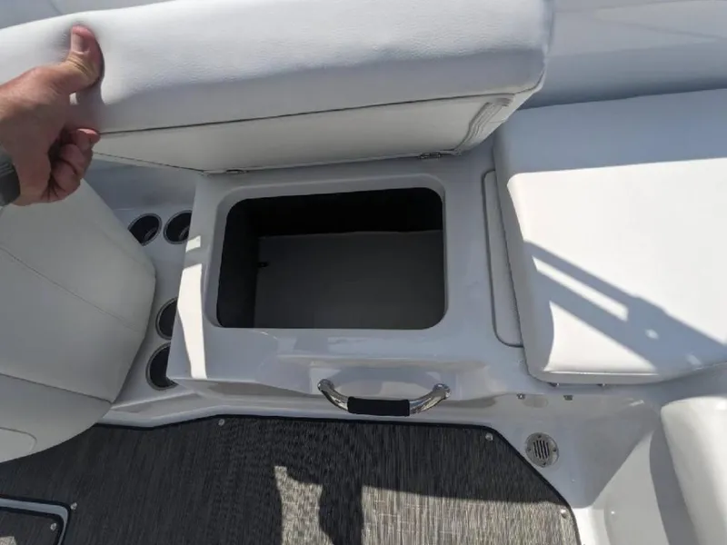Slide: The Image of 2023 Four Winns H1 OB boat storage compartment with open seat cushion. - 20