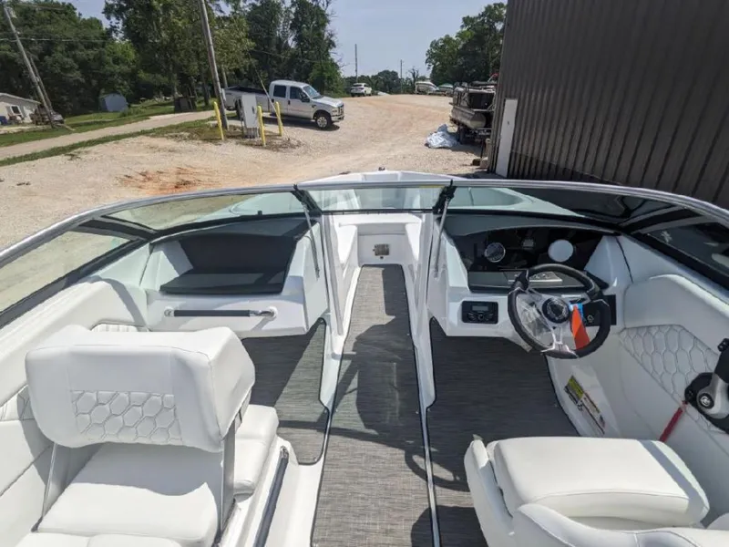 Slide: The Image of 2023 Four Winns H1 OB boat interior with white seating and modern dashboard. - 4