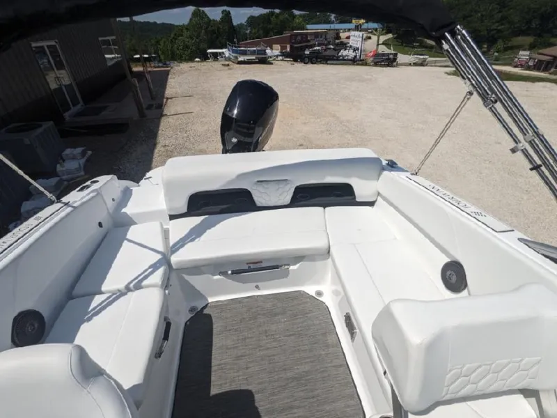Slide: The Image of 2023 Four Winns H1 OB boat interior with white seating and outboard motor. - 8