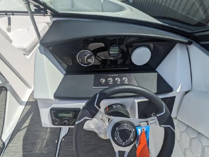 Slide: The Image of 2023 Four Winns H1 OB boat dashboard with steering wheel and control panel. - 9