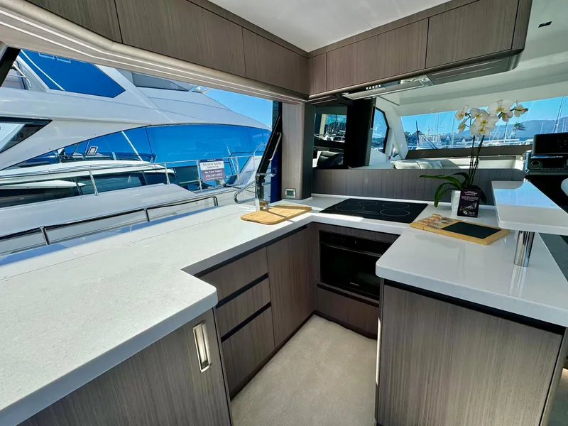 Slide: The Image of Modern kitchen interior of 2025 Galeon 500 Fly yacht, featuring sleek countertops and cabinetry. - 10