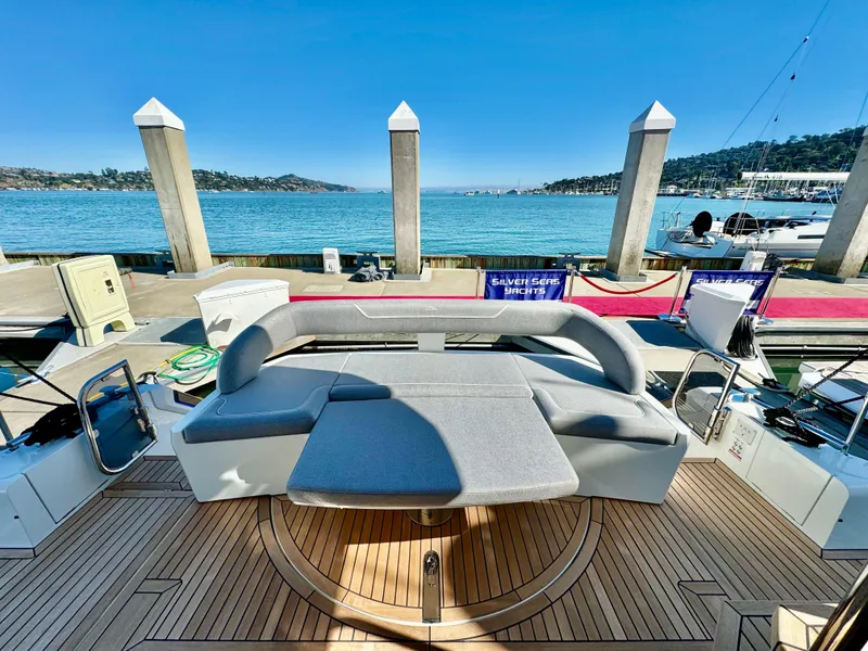 Slide: The Image of 2025 Galeon 500 Fly yacht with elegant deck seating at a marina. - 12