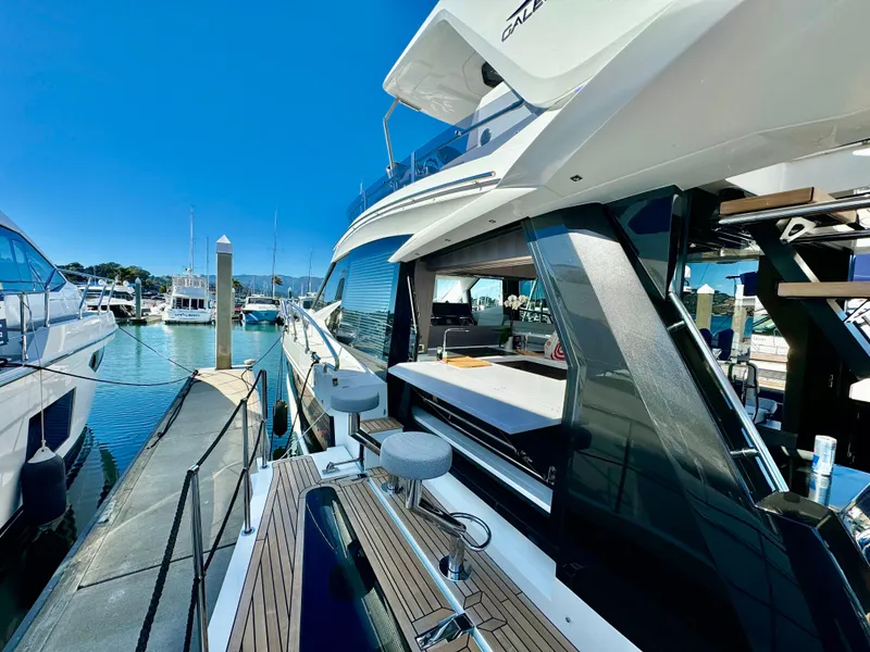 Slide: The Image of 2025 Galeon 500 Fly yacht docked at marina under clear blue sky. - 15