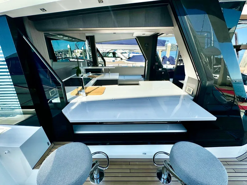 Slide: The Image of 2025 Galeon 500 Fly yacht interior with modern seating and sleek design. - 16
