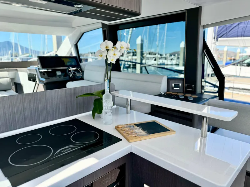 Slide: The Image of Luxurious interior of 2025 Galeon 500 Fly yacht with modern kitchen and scenic marina view. - 18