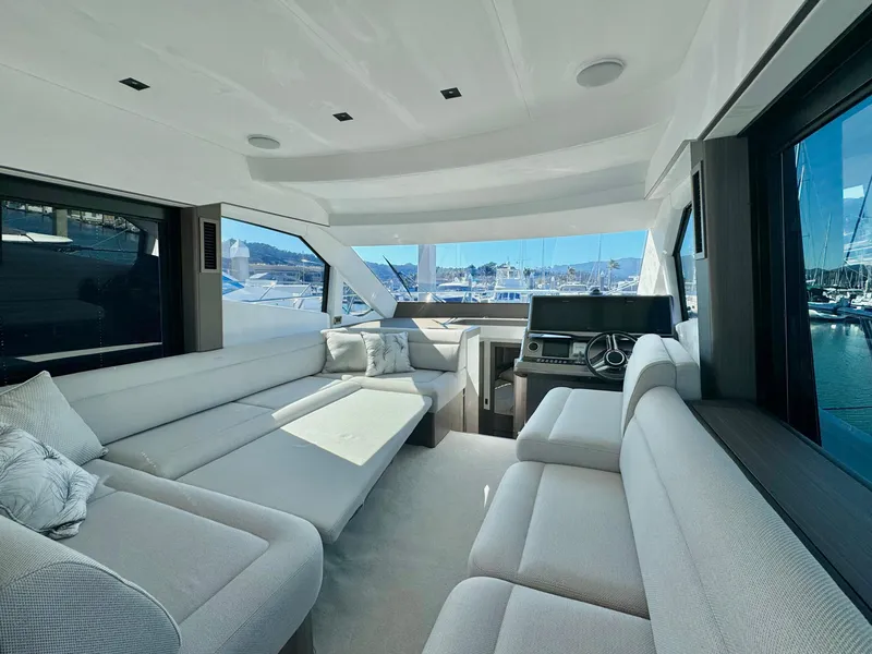 Slide: The Image of Luxurious interior of 2025 Galeon 500 Fly yacht with spacious seating and panoramic windows. - 19