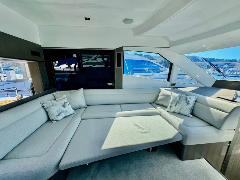 Slide: The Image of Luxurious interior of 2025 Galeon 500 Fly yacht with plush seating and scenic windows. - 20