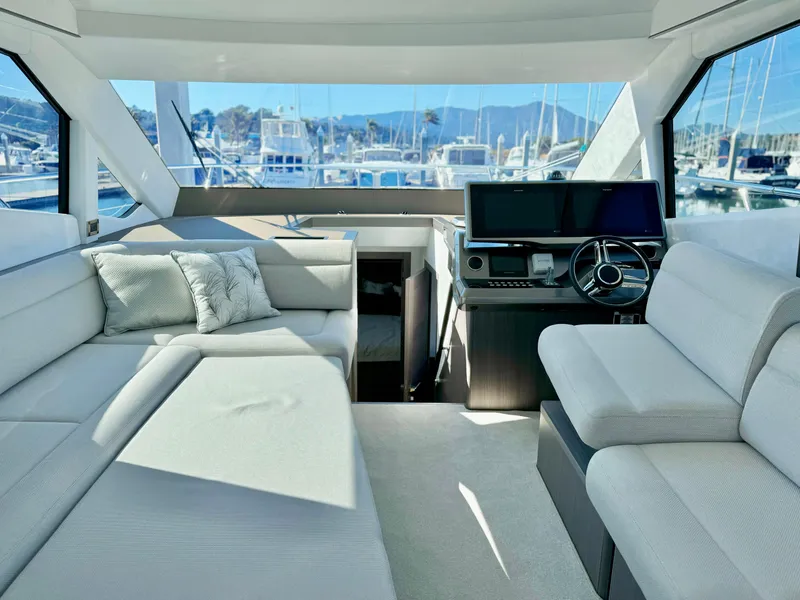 Slide: The Image of Luxurious interior of 2025 Galeon 500 Fly yacht with modern seating and helm. - 21