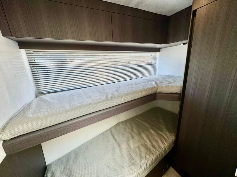 Slide: The Image of 2025 Galeon 500 Fly yacht interior with cozy bunk beds and modern wood finish. - 26