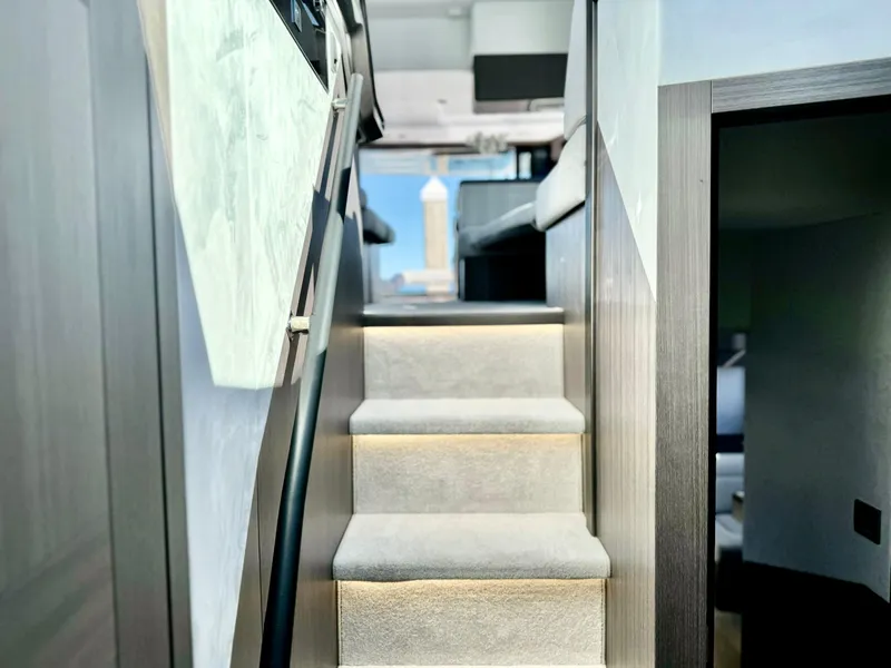 Slide: The Image of Staircase inside 2025 Galeon 500 Fly yacht, featuring modern design and ambient lighting. - 29