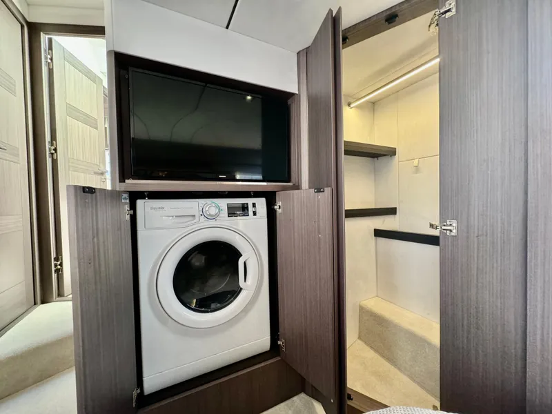 Slide: The Image of Laundry area with washer and TV in 2025 Galeon 500 Fly yacht. - 41