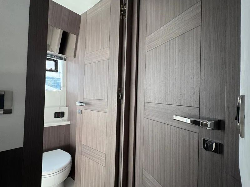 Slide: The Image of Modern bathroom interior on 2025 Galeon 500 Fly yacht, featuring sleek wood paneling and fixtures. - 42