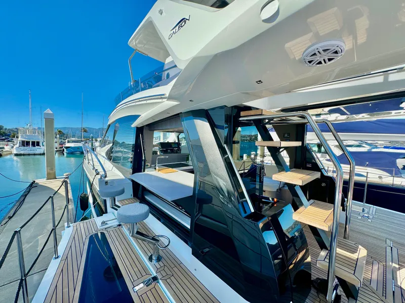 Slide: The Image of 2025 Galeon 500 Fly yacht docked at marina, showcasing sleek design and modern amenities. - 46