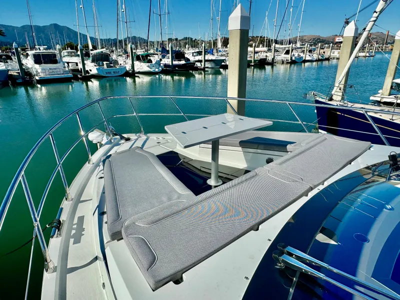 Slide: The Image of 2025 Galeon 500 Fly yacht with spacious deck seating in a marina. - 48