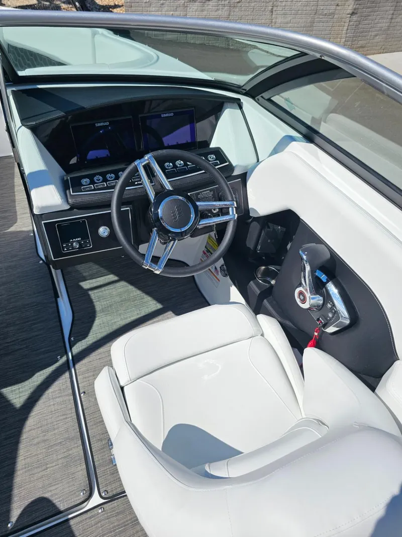 Slide: The Image of 2025 Four Winns H4 boat cockpit with modern steering wheel and controls. - 11