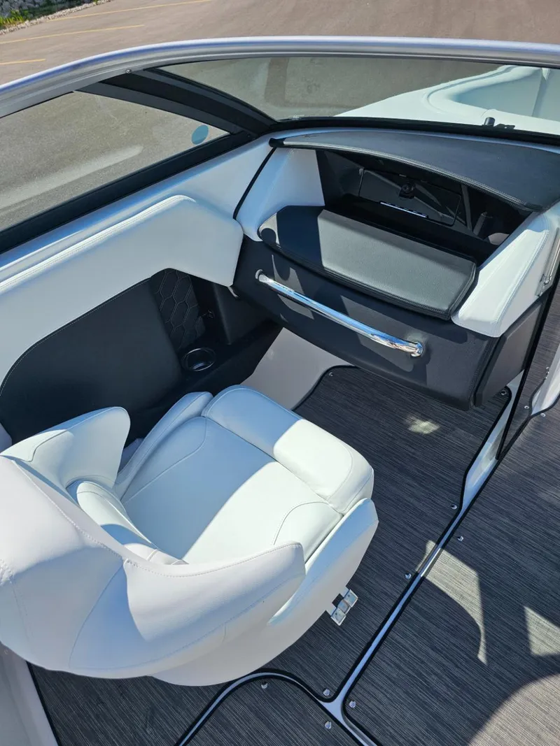 Slide: The Image of 2025 Four Winns H4 boat interior with white seating and dashboard. - 12