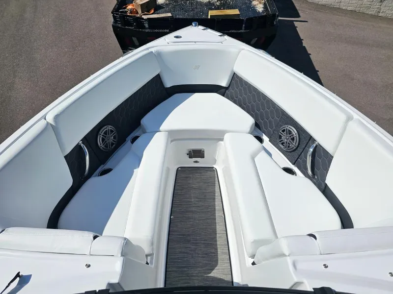 Slide: The Image of 2025 Four Winns H4 boat interior with white seating and built-in speakers. - 13