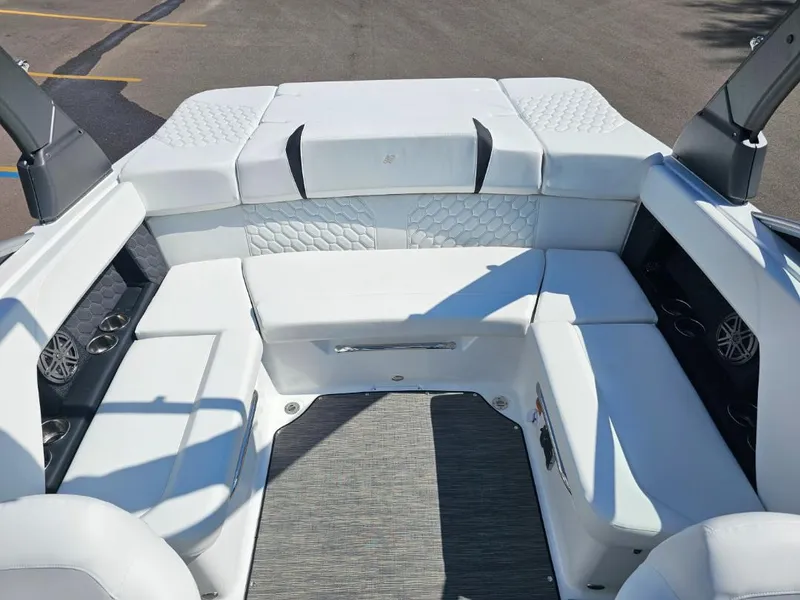 Slide: The Image of 2025 Four Winns H4 boat interior with white cushioned seating and modern design. - 15
